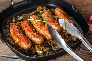 fried sausages in a skillet