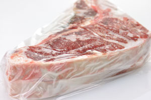 Frozen steak wrapped in plastic