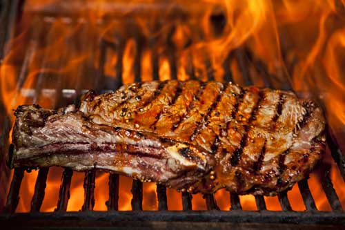 Bison rib steak on a barbecue