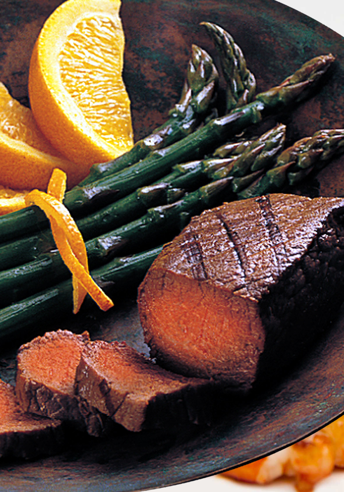 OSTRICH STEAK WITH ASPARAGUS ON A PLATE