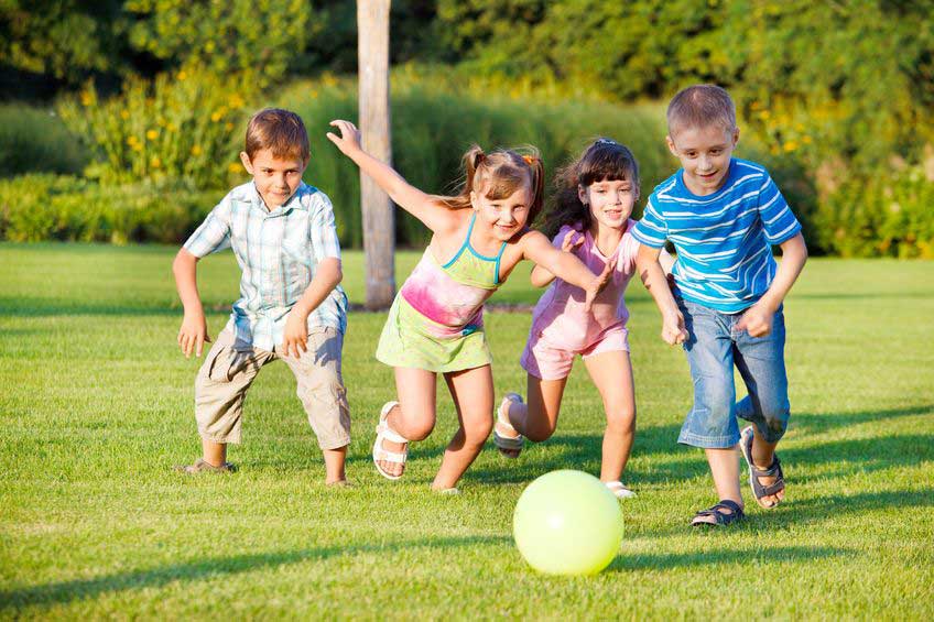 children playing with a ball in the grass
