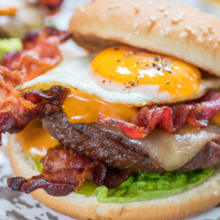 classic burger topped with bacon, cheese and an egg